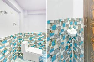 a bathroom with a toilet and a sink at Hotel o Skylight in New Delhi