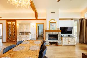 a dining room with a table and a fireplace at Villa Eliyas near the Pirin Golf Resort in Razlog