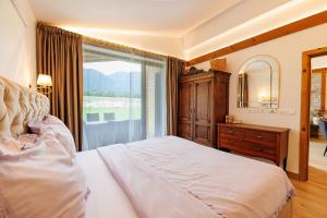 a bedroom with a large bed and a large window at Villa Eliyas near the Pirin Golf Resort in Razlog +35 photos