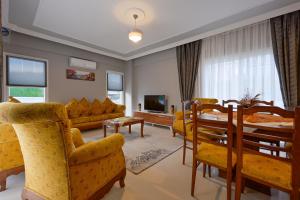 a living room with a couch and a table and chairs at Villa Egeden 2 in Fethiye
