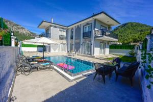 a villa with a swimming pool and a house at Villa Egeden 2 in Fethiye