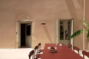 a dining room with a table and chairs at Moshoviti Residence in Rethymno