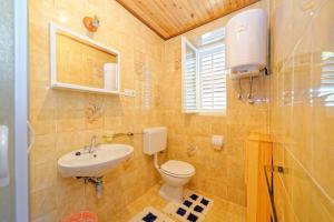 a bathroom with a toilet and a sink at Rooms Milica in Palit