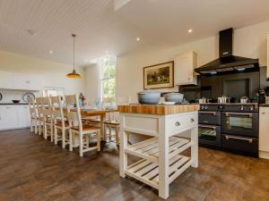 a kitchen with a table and some chairs in it at 7 Bed in Dollar oc-88668 in Powmill