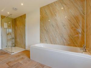 a bathroom with a tub and a glass shower at 7 Bed in Dollar oc-88668 in Powmill +33 photos