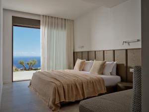 a bedroom with two beds and a view of the ocean at On The Rocks 7 Bedroom Villa in Koríthion +69 photos