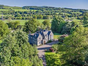 an aerial view of a house in the countryside at 7 Bed in Dollar oc-88668 in Powmill