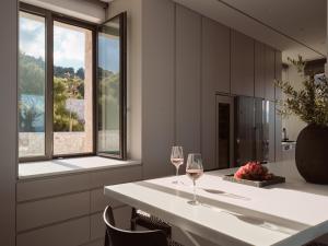 a kitchen with a table with two glasses of wine at On The Rocks 7 Bedroom Villa in Koríthion