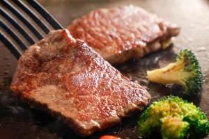 a steak and broccoli on a plate with a fork at HOTEL MYSTAYS Fuji Onsen Resort in Fujiyoshida