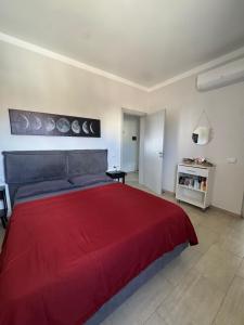 a bedroom with a large red bed in a room at Casa El Mundo in Sal Rei