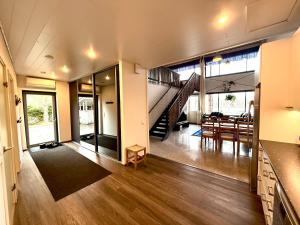 a living room with a staircase and a dining room at Villa Cuisine in Joensuu +18 photos