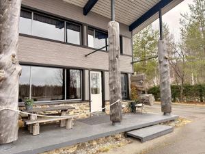 a house with a picnic table and a bench at Villa Cuisine in Joensuu