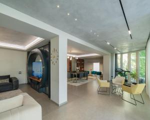 a living room with a white couch and chairs at Villa Florence in Tirana