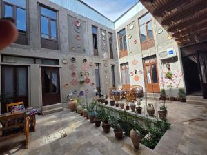 a building with a bunch of potted plants in it at Gulnaraxanum Boutique Hotel Premium in Bukhara