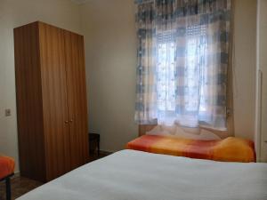 a bedroom with a bed and a window at Florina Appartment in Capo dʼOrlando