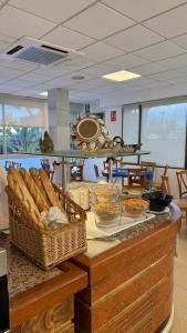 a counter with baskets of food on top of it at Hotel Stella Maris in Blanes