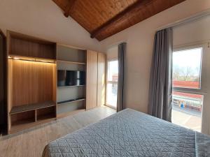 a bedroom with a bed and a large window at Antica Jesolo - M Factory in Jesolo