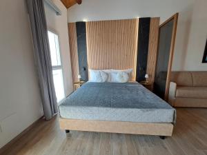 a bedroom with a bed with a blue comforter at Antica Jesolo - M Factory in Jesolo