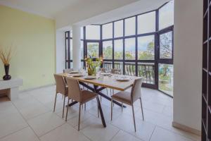 a dining room with a table and chairs and windows at Spacious 3BR Retreat Overlooking Marina in Msida