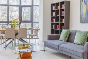 a living room with a couch and a table at Spacious 3BR Retreat Overlooking Marina in Msida +85 photos