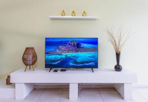 a tv sitting on top of a white table at Spacious 3BR Retreat Overlooking Marina in Msida