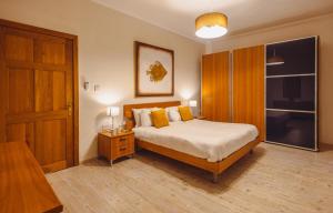 a bedroom with a bed and a wooden door at Spacious 3BR Retreat Overlooking Marina in Msida