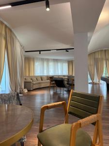 a living room with a couch and a table and chairs at Villa Florence in Tirana +161 photos