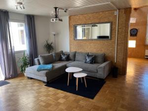 a living room with a couch and a table at Schwarzwald Lodge OG - Perfekt für Familien und Gruppen in Calw