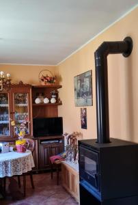 a living room with a stove and a table at Respiro di montagna by Lago Maggiore Rentals in Vigino +32 photos