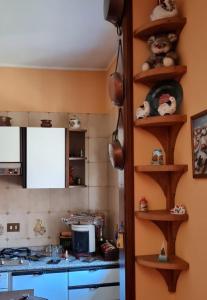 a kitchen with wooden shelves on the wall at Respiro di montagna by Lago Maggiore Rentals in Vigino