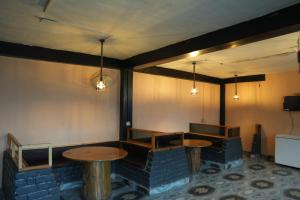 a restaurant with two tables in a room at The Himalayan Drift Cottages in Vashisht +31 photos