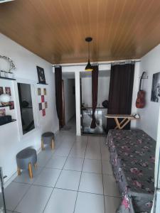 a bedroom with a bed and a table and chairs at Mandalas Guest House in Cabo Frio