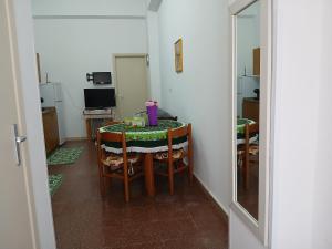 a dining room with a table and chairs with a mirror at Florina Appartment in Capo dʼOrlando +7 photos
