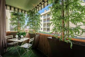 a restaurant with potted plants and a table and chairs at Bed&Dreams con Jacuzzi in Bergamo