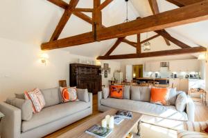 a living room with two couches and a table at The Coach House in Barlestone +13 photos