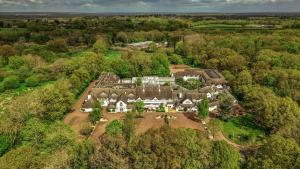 an aerial view of a large house in the woods at Basingstoke Hotel in Hook +69 photos