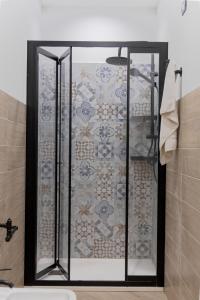a shower with a glass door in a bathroom at Scorcio di Mare By Dimora Hub in Balestrate +72 photos