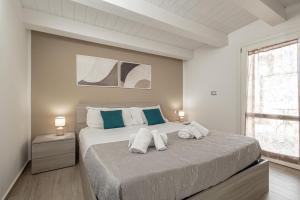 a bedroom with a large bed with two pillows on it at Terrasini Center Apartments By Dimora Hub in Terrasini