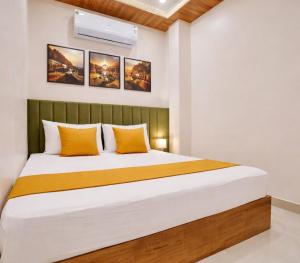 a bedroom with a large bed with yellow pillows at Anushka Stays Varanasi in Varanasi
