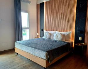 a bedroom with a large bed with a large window at Antica Jesolo - M Factory in Jesolo