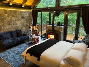 a bedroom with a large bed and a fireplace at AYDER VANAK SUİTEs in Ayder Yaylasi