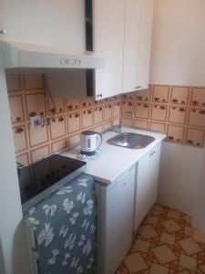 a small kitchen with a sink and a counter at Casa Maria Naxos in Giardini Naxos