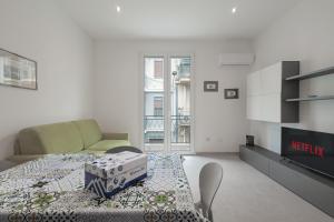 a living room with a table and a couch at Marusu Apartments By Dimora Hub in Terrasini