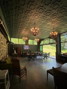 a large room with tables and chairs and a chandelier at AYDER VANAK SUİTEs in Ayder Yaylasi