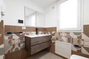 a bathroom with a sink and a mirror at Marusu Apartments By Dimora Hub in Terrasini +57 photos