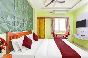 a bedroom with a bed and a table and a chair at Starlight Hotels DLF Trade Center Miot chennai in Chennai