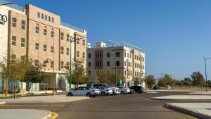 a group of cars parked in front of a building at Corp Yanbu Hotel - B2 in Yanbu