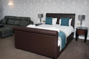 a bedroom with a large bed and a couch at Basingstoke Hotel in Hook