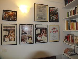 a wall with posters and books on it at Locanda Laudomia in Manciano