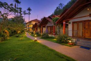 a row of houses with a fire hydrant in the grass at Hill Crest Resort - Coorg in Madikeri